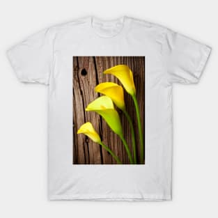 Calla lilies against wooden wall T-Shirt